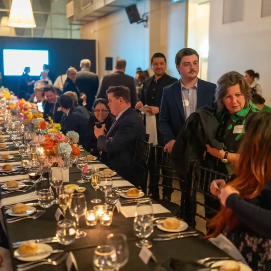 Guests seated at a long dinner table at a Svenson Barristers event
