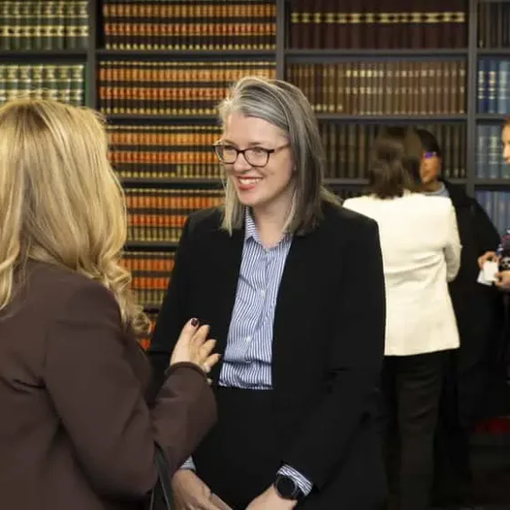 Svenson Barristers members talking in front of a law library