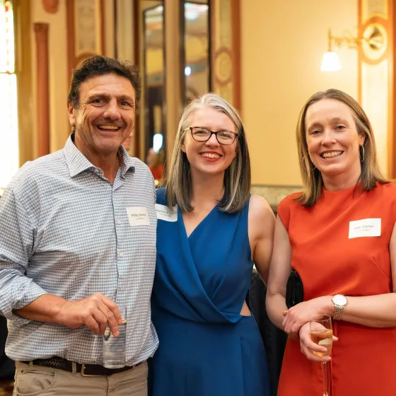 Three guests smiling at a Svenson Barristers event